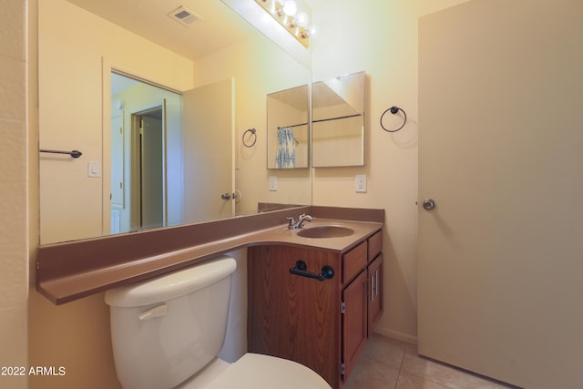 bathroom featuring tile patterned floors, vanity, and toilet