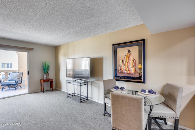 dining area with a textured ceiling and carpet floors