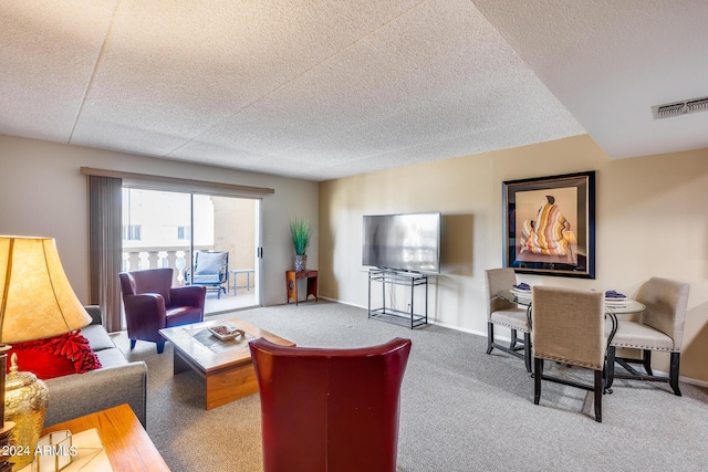 carpeted living room with a textured ceiling