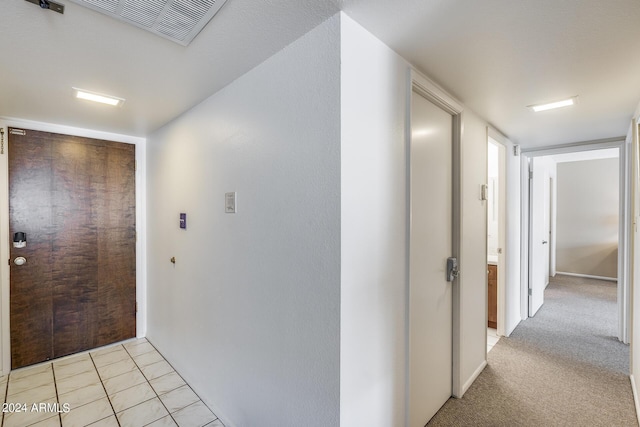 corridor with light tile patterned flooring