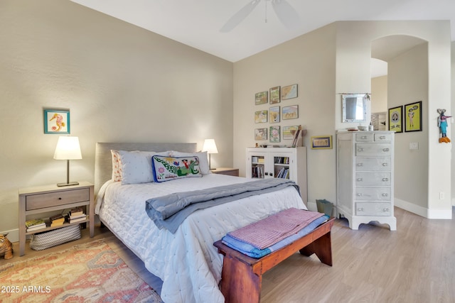 bedroom with ceiling fan, wood-type flooring, and vaulted ceiling