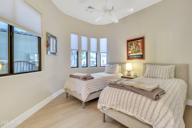 bedroom with light hardwood / wood-style floors and ceiling fan