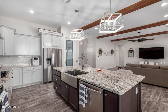 19436 W Windsor Ave, Buckeye, AZ 85396 - kitchen with stainless steel appliances, a sink, ceiling fan, beamed ceiling, and decorative backsplash