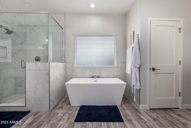 19436 W Windsor Ave, Buckeye, AZ 85396 - full bathroom with a marble finish shower, a freestanding bath, wood finished floors, tile walls, and recessed lighting
