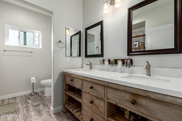 19436 W Windsor Ave, Buckeye, AZ 85396 - bathroom with toilet, baseboards, wood finished floors, and double vanity
