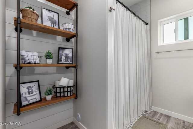 19436 W Windsor Ave, Buckeye, AZ 85396 - full bathroom featuring wood finished floors, baseboards, and curtained shower