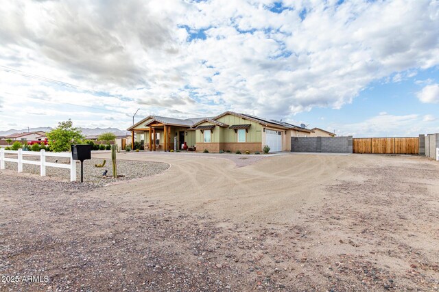 19436 W Windsor Ave, Buckeye, AZ 85396 - ranch-style house with curved driveway, a garage, fence, and a gate