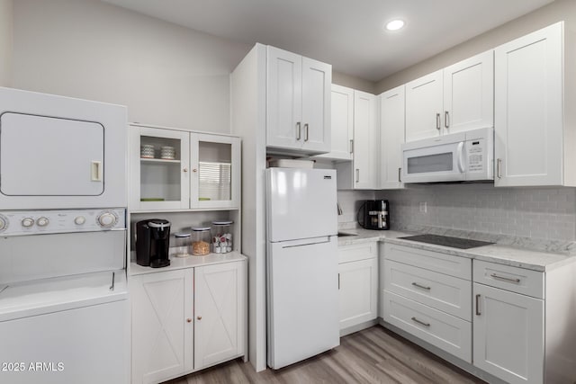19436 W Windsor Ave, Buckeye, AZ 85396 - kitchen featuring white appliances, stacked washer / drying machine, white cabinetry, light wood-style flooring, and recessed lighting