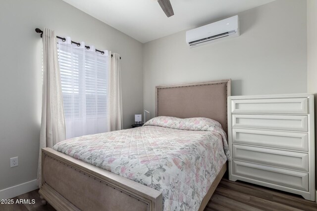 19436 W Windsor Ave, Buckeye, AZ 85396 - bedroom featuring an AC wall unit, dark wood-type flooring, baseboards, and ceiling fan