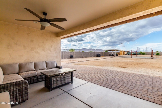 19436 W Windsor Ave, Buckeye, AZ 85396 - view of patio / terrace with ceiling fan, an outdoor hangout area, a fenced backyard, and a mountain view