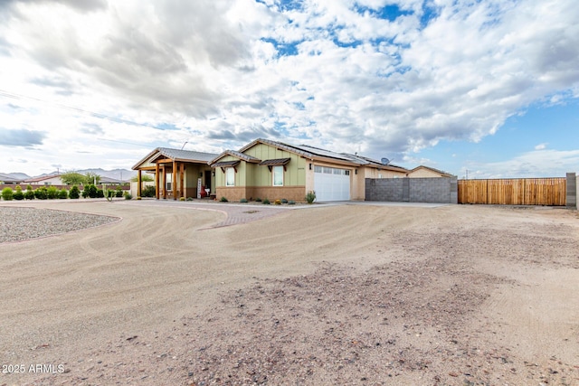19436 W Windsor Ave, Buckeye, AZ 85396 - single story home featuring dirt driveway, fence, a garage, solar panels, and covered porch