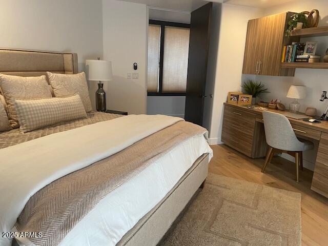41576 N 107th Way, Scottsdale, AZ 85262 - bedroom featuring built in desk and light wood-style flooring