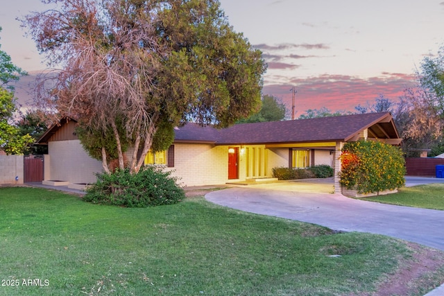 645 S Esquire Way, Mesa, AZ 85202 - single story home featuring brick siding, curved driveway, and a front yard