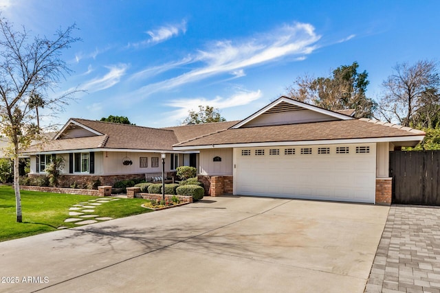 ranch-style home with a front lawn and a garage