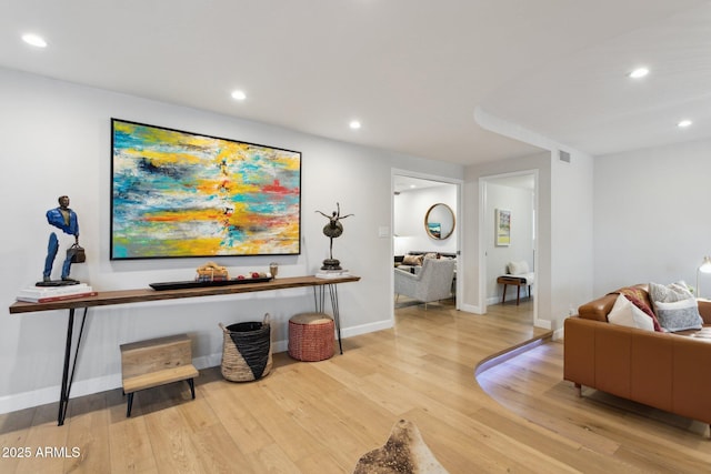 interior space featuring baseboards, light wood-type flooring, visible vents, and recessed lighting