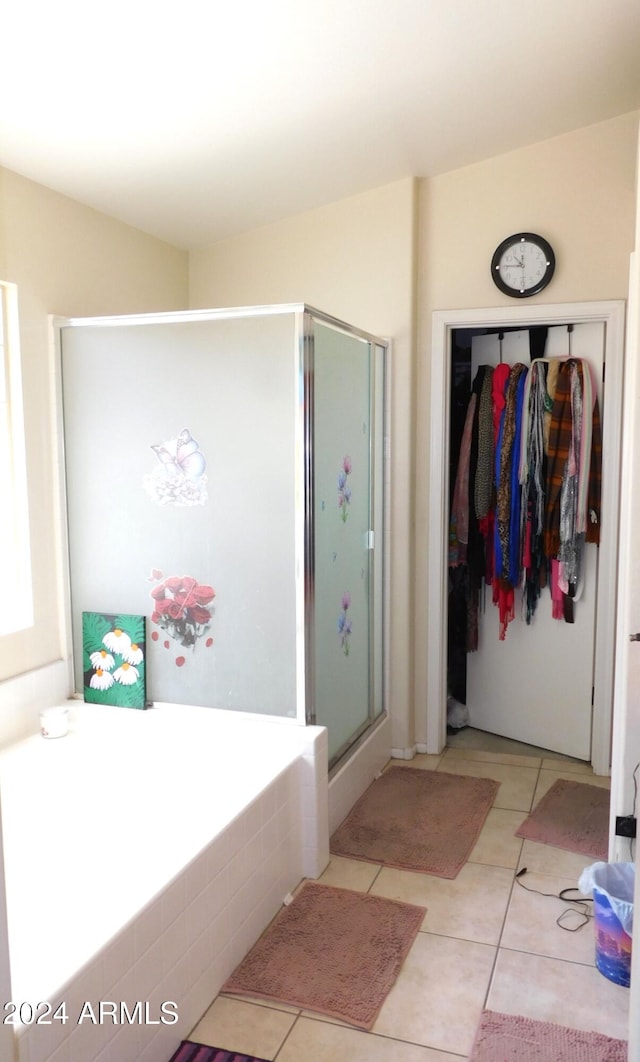 bathroom with tile patterned flooring and separate shower and tub