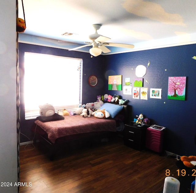 bedroom with ceiling fan and dark hardwood / wood-style floors