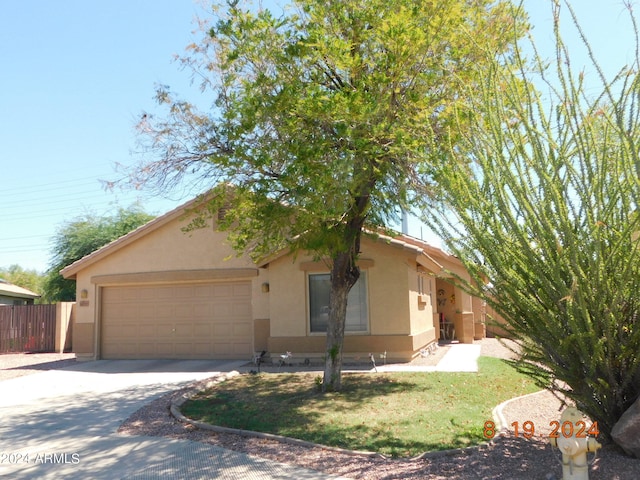 view of front facade with a garage and a front lawn