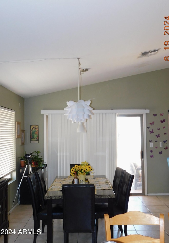 tiled dining area featuring lofted ceiling