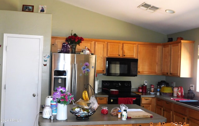 kitchen featuring lofted ceiling and black appliances