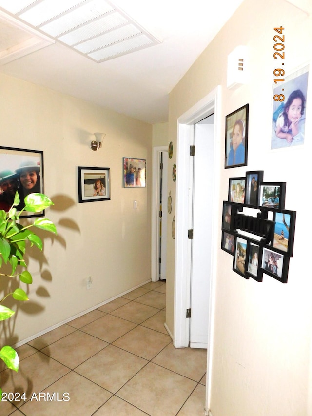 hall featuring light tile patterned floors