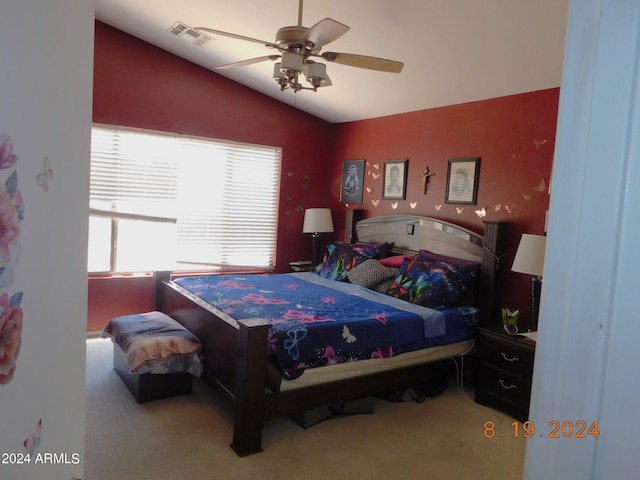 bedroom featuring ceiling fan, vaulted ceiling, and carpet