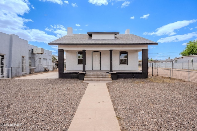 bungalow-style house with fence, a chimney, and stucco siding