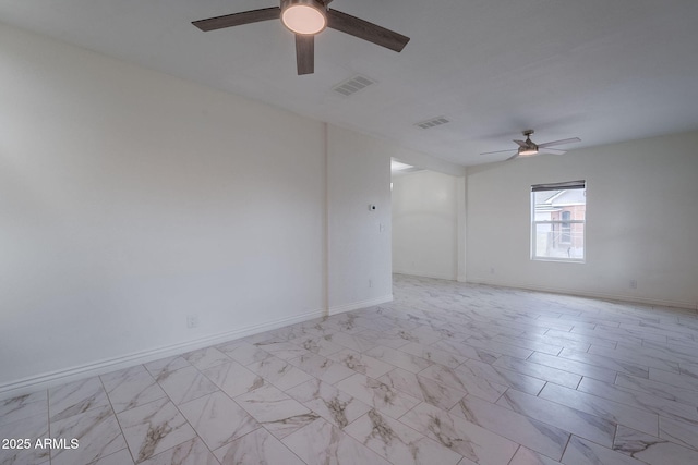unfurnished room featuring ceiling fan, visible vents, and baseboards