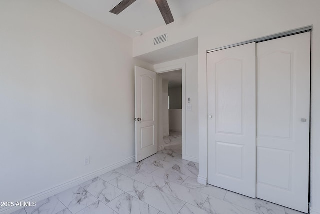 unfurnished bedroom featuring a ceiling fan, visible vents, baseboards, a closet, and marble finish floor