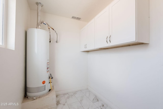 utilities with gas water heater and visible vents
