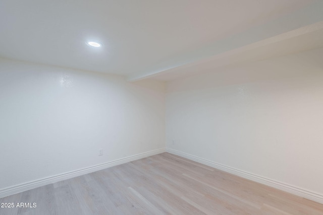 spare room with recessed lighting, baseboards, and light wood finished floors