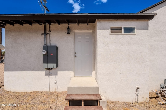 doorway to property with stucco siding