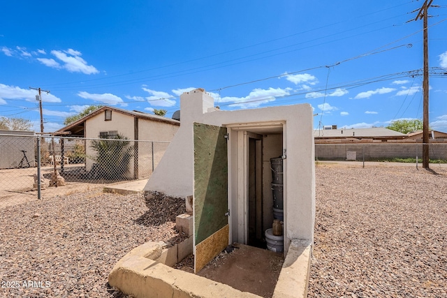 view of outbuilding with fence
