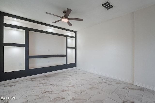 empty room with ceiling fan, visible vents, baseboards, and marble finish floor
