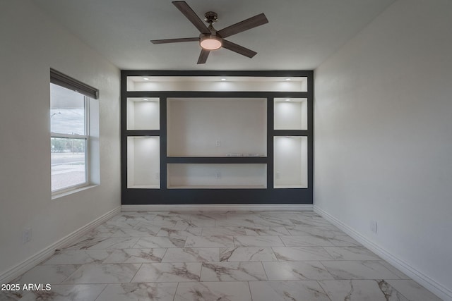 interior space with baseboards, ceiling fan, and marble finish floor