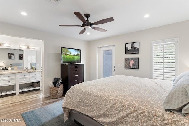 bedroom with recessed lighting, ensuite bathroom, a ceiling fan, and wood finished floors