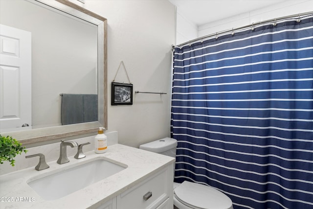 bathroom featuring vanity, toilet, and a shower with curtain