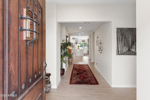 foyer featuring visible vents, recessed lighting, and baseboards