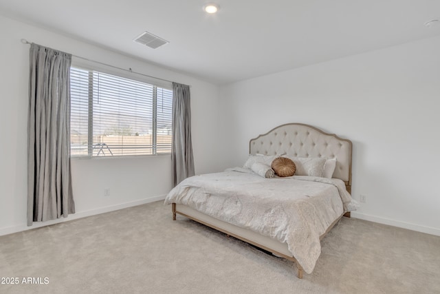 carpeted bedroom with visible vents and baseboards