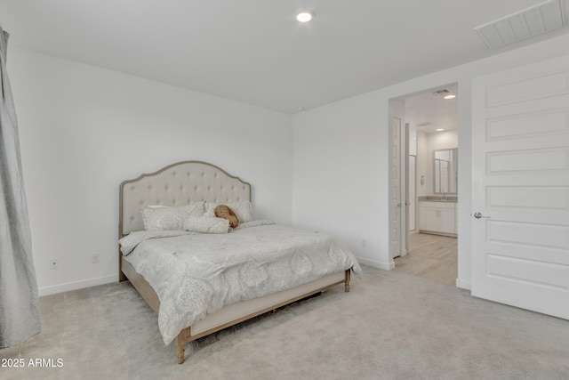 bedroom featuring light carpet, baseboards, visible vents, ensuite bathroom, and recessed lighting