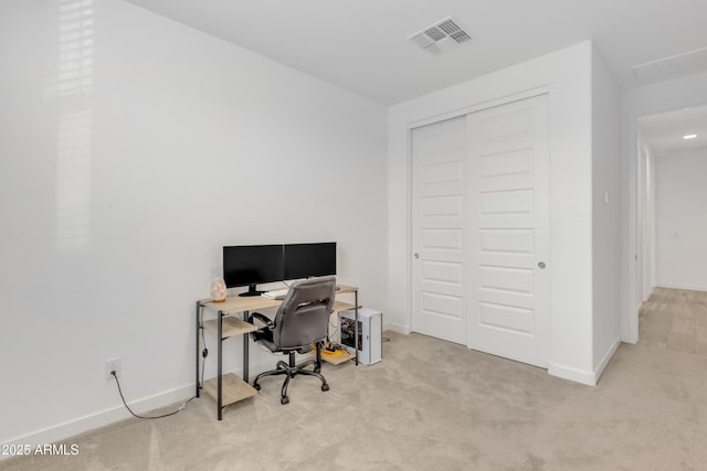 carpeted office featuring visible vents and baseboards