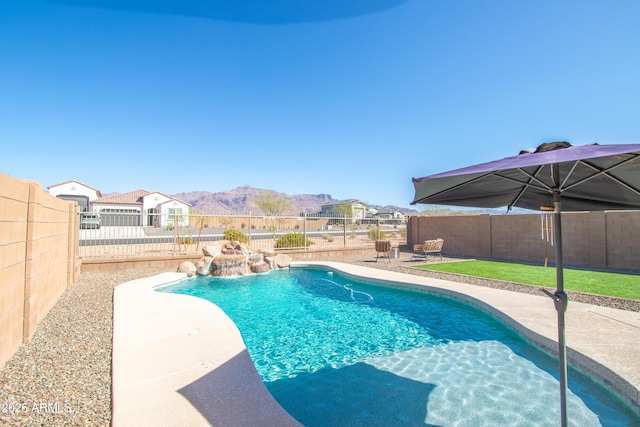 view of pool with a fenced in pool, a patio area, a fenced backyard, and a mountain view