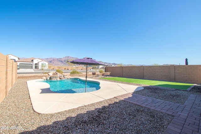 view of swimming pool with a patio area, a fenced backyard, a mountain view, and a fenced in pool