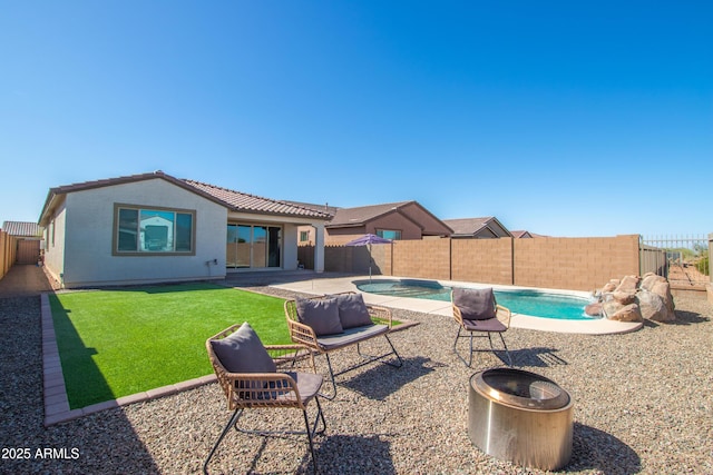 exterior space with a fenced in pool, a fenced backyard, a tile roof, a patio area, and stucco siding