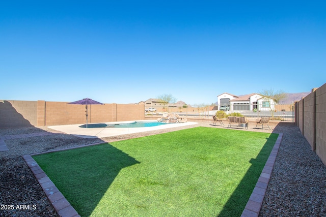 view of yard featuring a fenced in pool, a patio area, and a fenced backyard