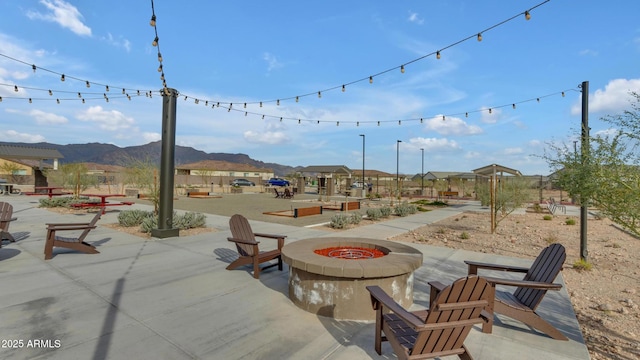 view of patio featuring a mountain view and a fire pit