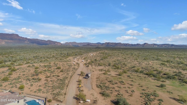 drone / aerial view featuring view of desert and a mountain view