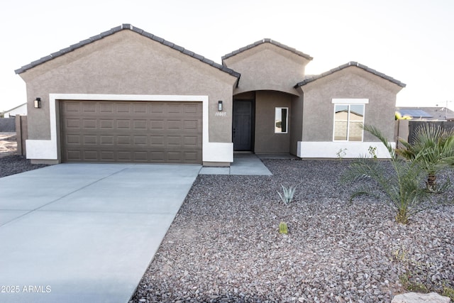 ranch-style house with stucco siding, driveway, a tile roof, and a garage