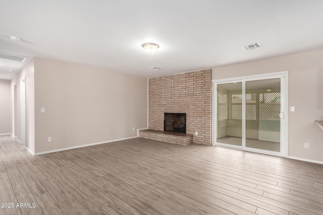 9803 N 40th Dr, Phoenix, AZ 85051 - unfurnished living room with wood finished floors, a fireplace, and baseboards