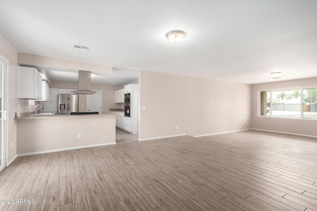 9803 N 40th Dr, Phoenix, AZ 85051 - unfurnished living room featuring light wood-style floors, baseboards, and a sink